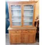 A 4' Victorian waxed pine dresser with painted plate shelves enclosed by a pair of glazed panel