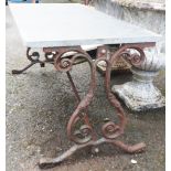 A wrought iron garden table with slate top - length 3' 2"