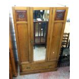 A 3' 7 1/2" early 20th Century stained oak wardrobe with hanging space enclosed by a mirror panel