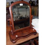 A Victorian figured mahogany platform dressing table mirror with arched plate and serpentine base