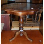 A 21" polished mixed wood Sorrento style pedestal table, set on turned pillar and tripod base