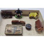 Five miniature cottages and two old tins