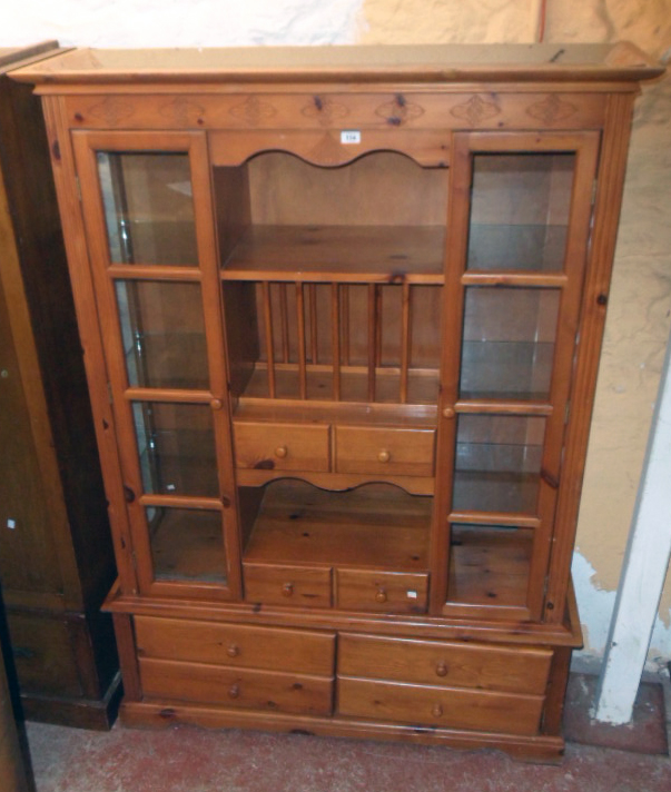 A 4' 4" modern stained pine and mixed wood two part dresser with central shelves, plate rack and