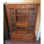 A 4' 4" modern stained pine and mixed wood two part dresser with central shelves, plate rack and