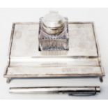 A Sheaffer silver desk set comprising inkstand, flip-top inkwell (top dented), and fountain pen