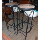 A pair of black painted wrought iron framed bar stools with branded cask top seat panels