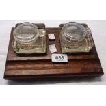 An oak inkstand with two glass inkwells