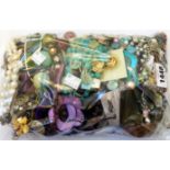 A bag containing a large quantity of assorted costume jewellery