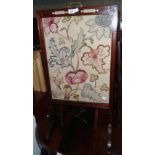 A Victorian walnut Chinese Chippendale style rise and fall fire screen with embroidered panel, set