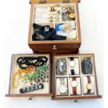 A polished wood jewellery chest containing dress ring, watches and costume jewellery