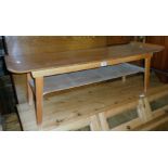 A 3' 8" retro stained mixed wood two tier coffee table, set on tapered legs