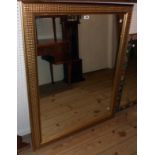 A modern gilt framed oblong wall mirror with decorative textured border - 3' 10" X 36"