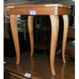 A souvenir musical work table with decorative lift top and slender cabriole legs