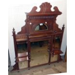 A 3' 8" Edwardian walnut overmantel mirror with decorative pediment, multiple bevelled plates,