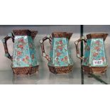A set of three graduated faceted majolica jugs, in the Oriental style