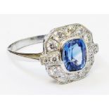 A marked PLAT 1920's style panel ring, set with central oval sapphire within a ten stone diamond