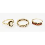 Three 9ct. gold rings set with garnets, etc.