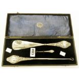 A cased set of silver handled button hooks and shoe horn