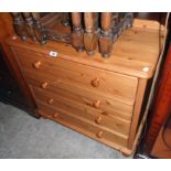 A 33" modern polished pine chest of four long drawers, set on pommel feet