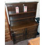 A 4' polished oak two part dresser in the antique style with two shelf open plate rack over a base