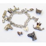 A white metal and silver charm bracelet, padlock and other loose charms