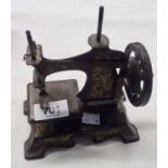 An antique German tin plate toy sewing machine, possibly Muller - number to plate obscure, tired