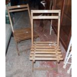 Two similar vintage slatted wood folding garden chairs