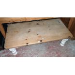 A 4' pine scrub-top coffee table, set on painted turned legs - adapted