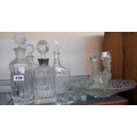 Four decanters, a glass candlestick and further glassware