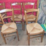 A set of four modern stained beech framed kitchen chairs with woven rush seats and square supports