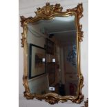 A modern ornate gilt framed wall mirror with plate in the antique style