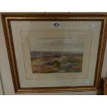 †C. E. Brittan: a gilt framed watercolour, depicting a moorland view with rocks in foreground at