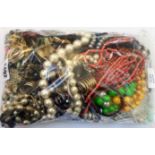 A bag containing a quantity of assorted costume jewellery