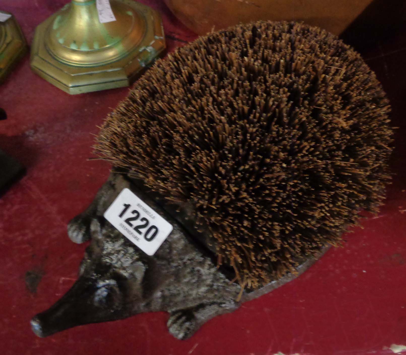 A modern reproduction cast iron hedgehog boot scraper