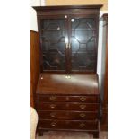 A 3' 3" late Georgian mahogany two part bureau bookcase with blind fret-work decoration to cornice