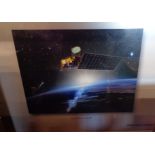 A framed print depicting The Northrop Grumman Aqua Spacecraft