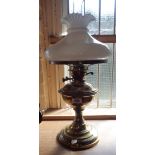 A Victorian brass table oil lamp with shade