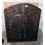 A triple folding fire screen in the antique style with decorative wrought iron work on mesh backing