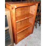 A 35" modern stained pine three shelf open bookcase with moulded decoration