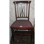 An Edwardian mahogany and strung bedroom chair with upholstered seat panel
