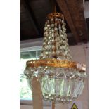 A gilt brass pendant light fitting with glass drops and lustres