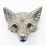 A 1 1/4" white metal and paste encrusted fox mask pattern brooch with garnet set eyes