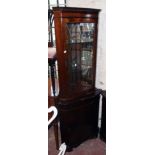 A 27" reproduction mahogany corner cabinet with glazed and mirrored top section over a cupboard