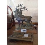 A pair of brass stags on wooden stands - sold with a small brass plaque