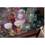 A collection of glassware including a pair of green glass vases, cranberry glass jug, cut glass