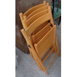 A set of four laminate folding garden chairs