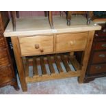 A 3' 3 1/2" scrub-top dele and stained pine preparation table with two deep frieze drawers, towel