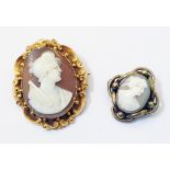 A 1 3/4" Victorian ornate yellow metal framed oval cameo brooch - sold with a smaller plated