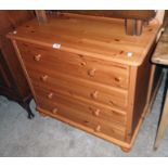 A 33 1/2" modern polished pine chest of four long drawers, set on pommel feet