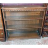 A 36" 20th Century polished oak and mixed wood three shelf open bookcase